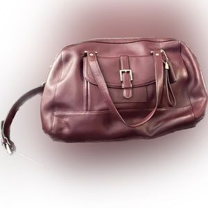 Purple coach bag with handles and crossbody strap
